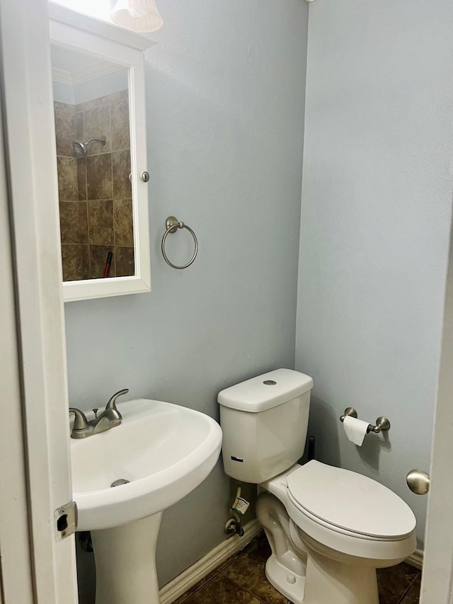 1301 Cherie Brook Dr, Goliad, TX 77963 - bathroom featuring baseboards, toilet, and tile patterned flooring