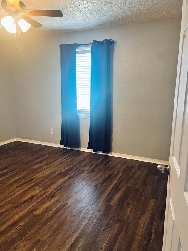 1301 Cherie Brook Dr, Goliad, TX 77963 - spare room with ceiling fan, wood finished floors, a textured ceiling, and baseboards