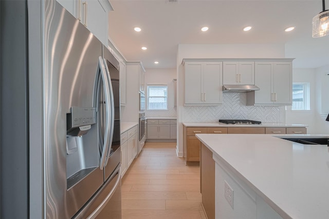 2610 Texas Orange Trl, Richmond, TX 77406 - kitchen with stainless steel fridge with ice dispenser, under cabinet range hood, decorative backsplash, recessed lighting, and light countertops
