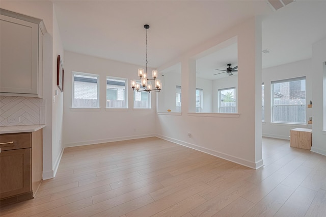 2610 Texas Orange Trl, Richmond, TX 77406 - unfurnished dining area featuring a chandelier, light wood finished floors, a ceiling fan, and baseboards