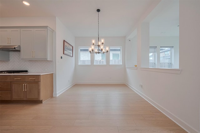 2610 Texas Orange Trl, Richmond, TX 77406 - unfurnished dining area featuring a chandelier, healthy amount of natural light, light wood-type flooring, baseboards, and recessed lighting