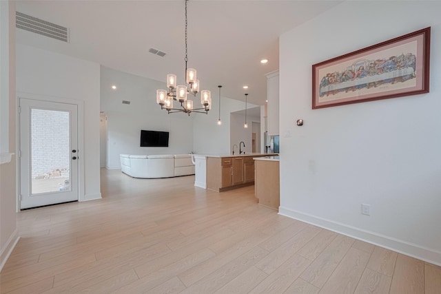 2610 Texas Orange Trl, Richmond, TX 77406 - kitchen featuring open floor plan, light wood-style flooring, light countertops, a chandelier, and baseboards