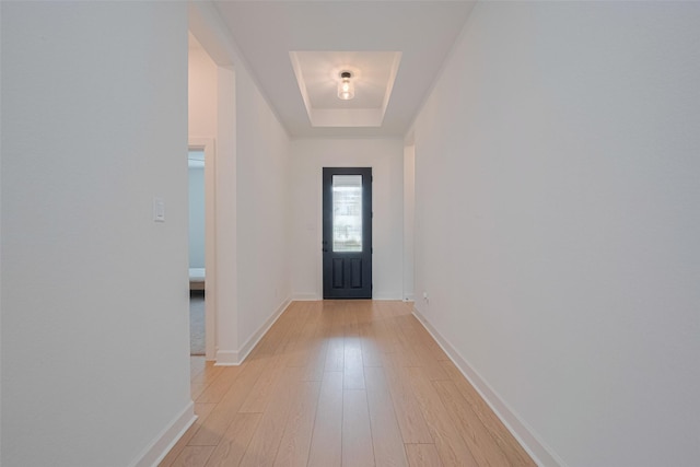 2610 Texas Orange Trl, Richmond, TX 77406 - doorway to outside featuring light wood-style flooring, a tray ceiling, and baseboards