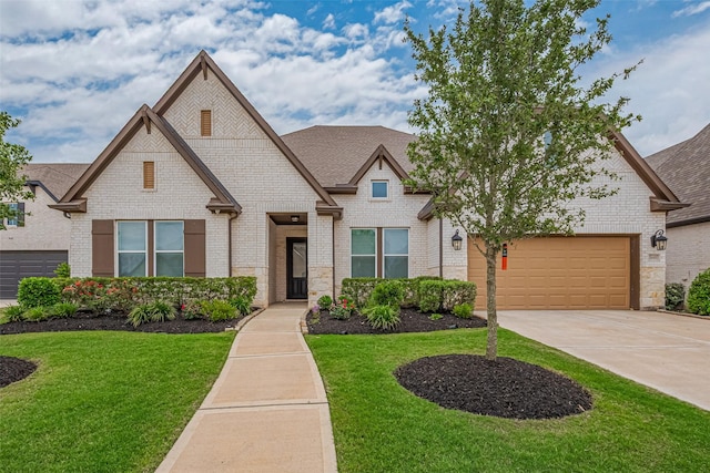 2610 Texas Orange Trl, Richmond, TX 77406 - view of front of house with brick siding, concrete driveway, a front lawn, and an attached garage