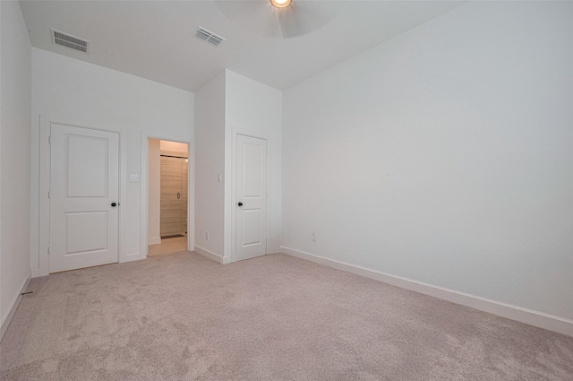 2610 Texas Orange Trl, Richmond, TX 77406 - unfurnished bedroom with light carpet, baseboards, lofted ceiling, and a ceiling fan