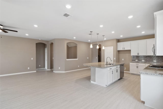 24730 Harbor Terrace Ln, Richmond, TX 77406 - kitchen featuring dishwasher, a sink, open floor plan, a ceiling fan, and a kitchen island with sink