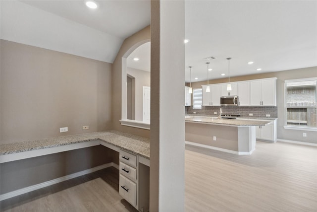 24730 Harbor Terrace Ln, Richmond, TX 77406 - kitchen featuring light wood-style floors, stainless steel microwave, range, white cabinets, and recessed lighting