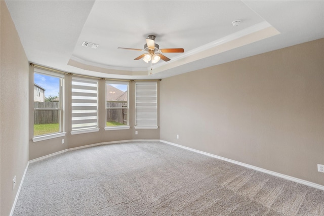 24730 Harbor Terrace Ln, Richmond, TX 77406 - spare room featuring a tray ceiling, a ceiling fan, carpet, baseboards, and ornamental molding