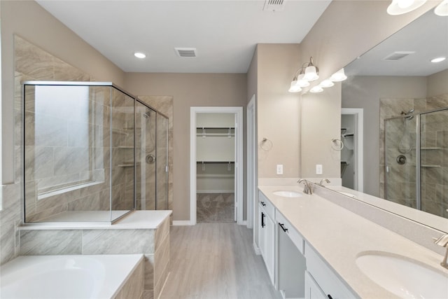 24730 Harbor Terrace Ln, Richmond, TX 77406 - full bathroom featuring a stall shower, a spacious closet, double vanity, tiled bath, and baseboards