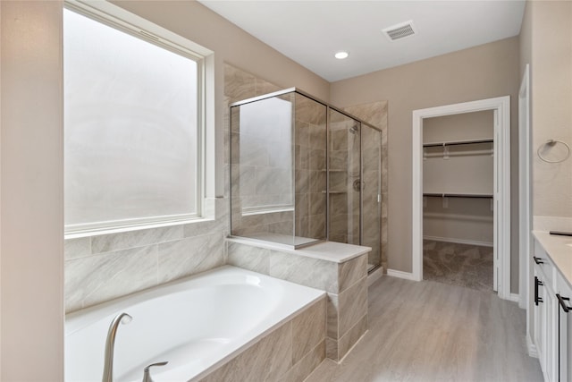 24730 Harbor Terrace Ln, Richmond, TX 77406 - bathroom with a stall shower, a spacious closet, a bath, and vanity
