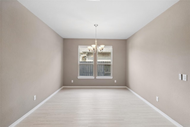 24730 Harbor Terrace Ln, Richmond, TX 77406 - spare room featuring light wood-type flooring, a chandelier, and baseboards