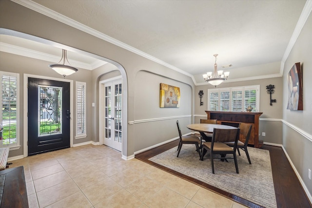 8514 Babbling Brook Ct, Sugar Land, TX 77479 - dining space with plenty of natural light, light tile patterned floors, a chandelier, crown molding, and baseboards