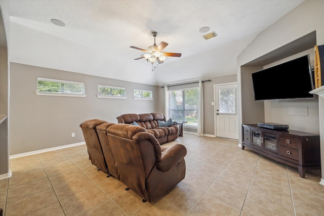8514 Babbling Brook Ct, Sugar Land, TX 77479 - living room featuring lofted ceiling, light tile patterned floors, ceiling fan, baseboards, and a textured ceiling