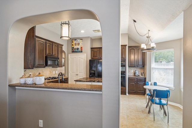 8514 Babbling Brook Ct, Sugar Land, TX 77479 - kitchen featuring black appliances, arched walkways, dark brown cabinetry, dark countertops, and decorative backsplash