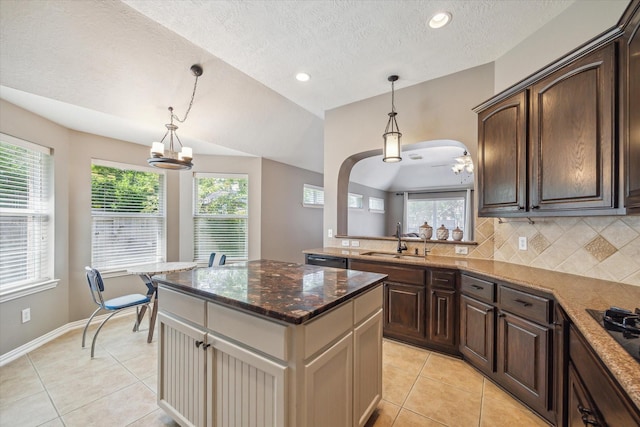 8514 Babbling Brook Ct, Sugar Land, TX 77479 - kitchen with a sink, light tile patterned flooring, a textured ceiling, dark brown cabinets, and recessed lighting