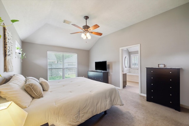8514 Babbling Brook Ct, Sugar Land, TX 77479 - bedroom featuring multiple windows, vaulted ceiling, light colored carpet, connected bathroom, and baseboards