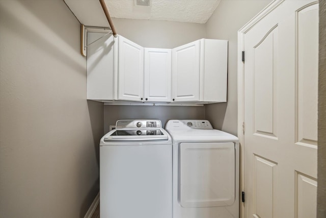 8514 Babbling Brook Ct, Sugar Land, TX 77479 - laundry room featuring cabinet space, washing machine and clothes dryer, and a textured ceiling