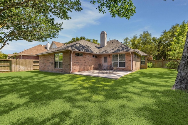 8514 Babbling Brook Ct, Sugar Land, TX 77479 - back of property featuring brick siding, a patio area, and a chimney
