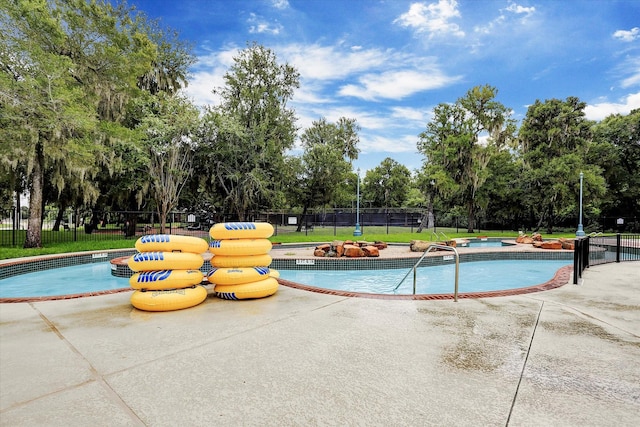 8514 Babbling Brook Ct, Sugar Land, TX 77479 - community pool featuring a hot tub, view of scattered trees, and a patio area