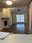 3100 Walnut Bend Ln Unit 508, Houston, TX 77042 - unfurnished living room featuring a fireplace and ceiling fan