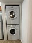 3100 Walnut Bend Ln Unit 508, Houston, TX 77042 - laundry area featuring estacked washer and dryer and baseboards