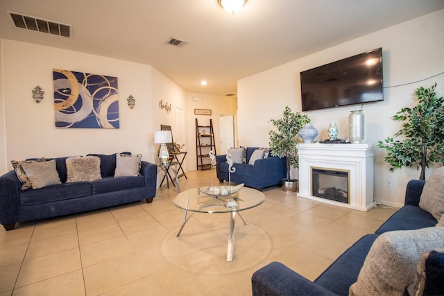 7735 Nevaeh Crest Path, Houston, TX 77016 - tiled living room with a glass covered fireplace