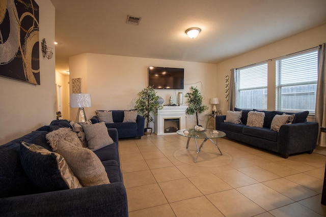 7735 Nevaeh Crest Path, Houston, TX 77016 - living area featuring light tile patterned floors and a fireplace