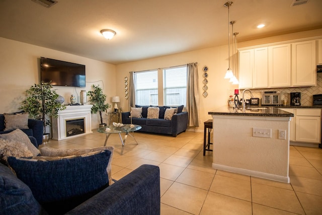 7735 Nevaeh Crest Path, Houston, TX 77016 - living room with light tile patterned flooring and a fireplace