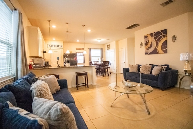 7735 Nevaeh Crest Path, Houston, TX 77016 - living area with light tile patterned floors and recessed lighting