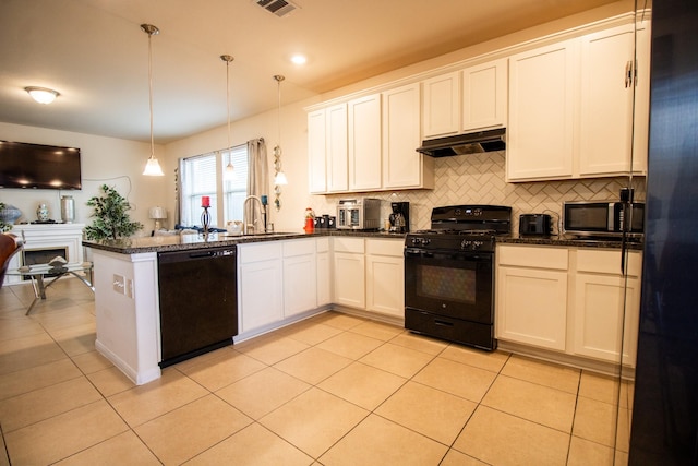 7735 Nevaeh Crest Path, Houston, TX 77016 - kitchen with black appliances, under cabinet range hood, a peninsula, backsplash, and a sink