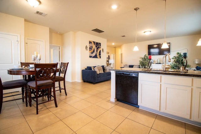 7735 Nevaeh Crest Path, Houston, TX 77016 - kitchen with black dishwasher, a sink, light tile patterned flooring, white cabinetry, and pendant lighting