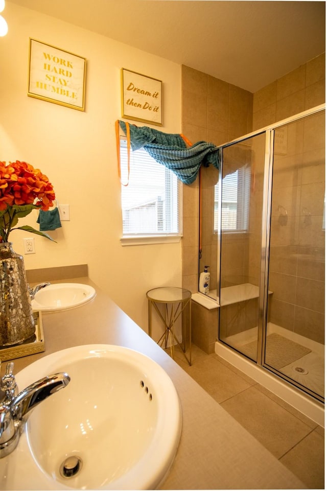 7735 Nevaeh Crest Path, Houston, TX 77016 - full bathroom featuring a stall shower, tile patterned flooring, and double sink