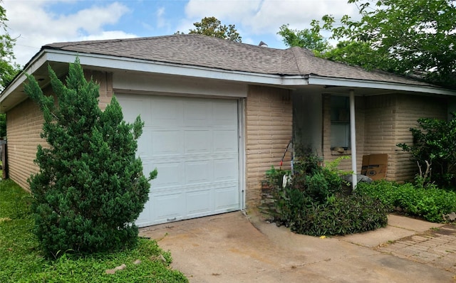 4826 Macridge Blvd, Houston, TX 77053 - view of property exterior with a shingled roof, an attached garage, brick siding, and concrete driveway