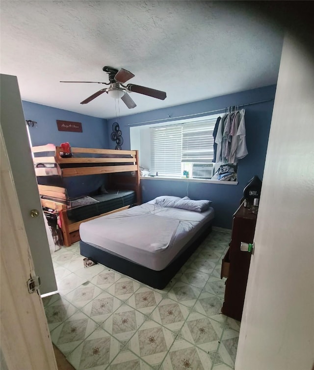 4826 Macridge Blvd, Houston, TX 77053 - bedroom featuring ceiling fan, tile patterned floors, cooling unit, and a textured ceiling