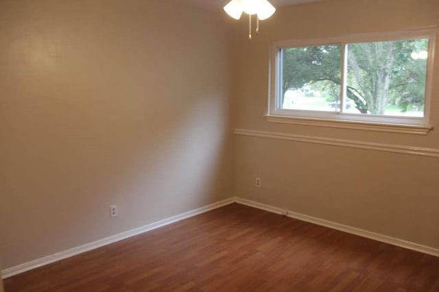 4906 Havenwoods Dr, Houston, TX 77066 - empty room with dark wood-style flooring, baseboards, and ceiling fan