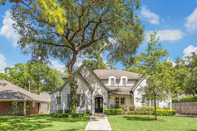 french country style house featuring french doors and brick siding