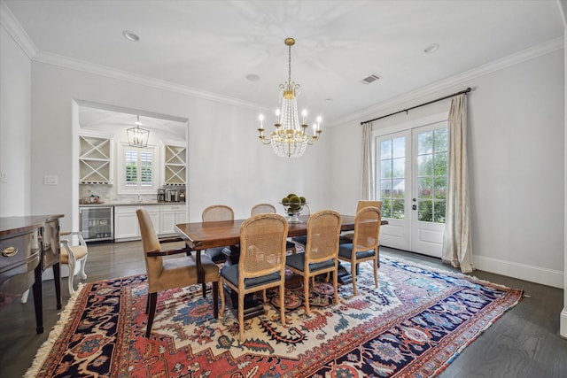 dining space with beverage cooler, healthy amount of natural light, french doors, wood finished floors, and crown molding