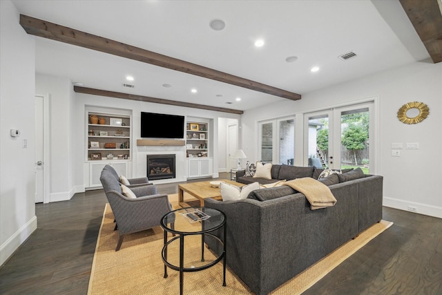 living area featuring beam ceiling, baseboards, a glass covered fireplace, dark wood finished floors, and recessed lighting