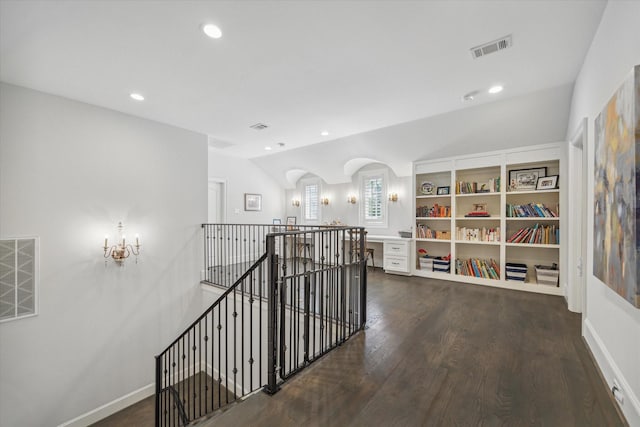 hallway featuring an upstairs landing, dark wood-style floors, recessed lighting, arched walkways, and lofted ceiling