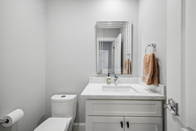half bath featuring toilet and vanity
