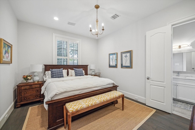 bedroom with a chandelier, dark wood-style flooring, ensuite bathroom, and baseboards