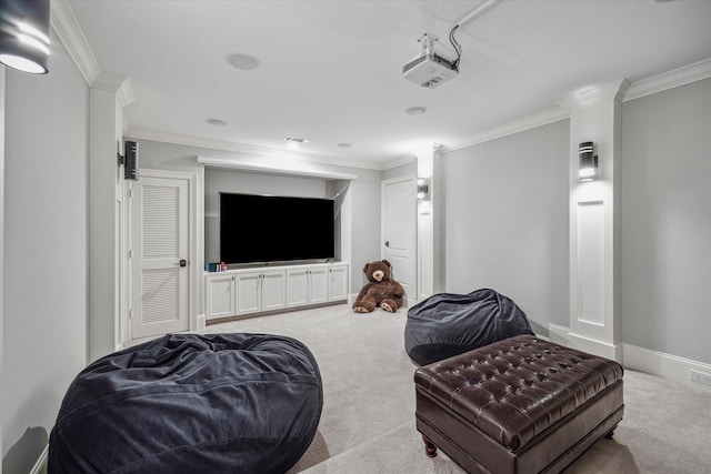 carpeted cinema room featuring ornamental molding and baseboards