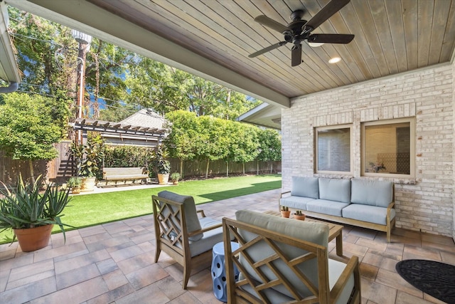 view of patio / terrace featuring an outdoor living space, ceiling fan, and a pergola