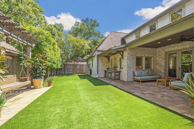 view of yard with a patio area, a pergola, a ceiling fan, and outdoor lounge area