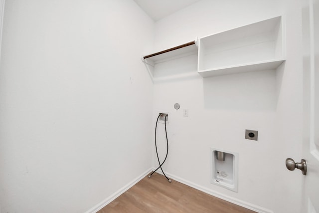 24063 Hawthorn Lakes Dr, New Caney, TX 77357 - washroom with electric dryer hookup, light wood-style floors, washer hookup, baseboards, and hookup for a gas dryer