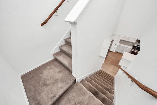 24063 Hawthorn Lakes Dr, New Caney, TX 77357 - staircase featuring baseboards and wood finished floors