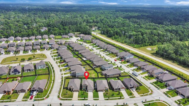 24063 Hawthorn Lakes Dr, New Caney, TX 77357 - aerial overview of property's location with a forest and nearby suburban area