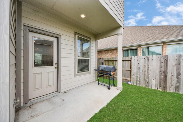 24063 Hawthorn Lakes Dr, New Caney, TX 77357 - view of exterior entry featuring a patio and roof with shingles