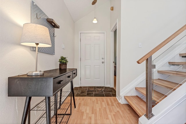 2300 Old Spanish Trl Unit 2059, Houston, TX 77054 - foyer featuring vaulted ceiling, stairway, wood finished floors, and baseboards