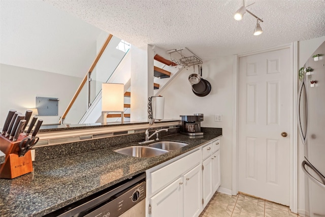 2300 Old Spanish Trl Unit 2059, Houston, TX 77054 - kitchen with a sink, white cabinetry, appliances with stainless steel finishes, dark stone counters, and a textured ceiling